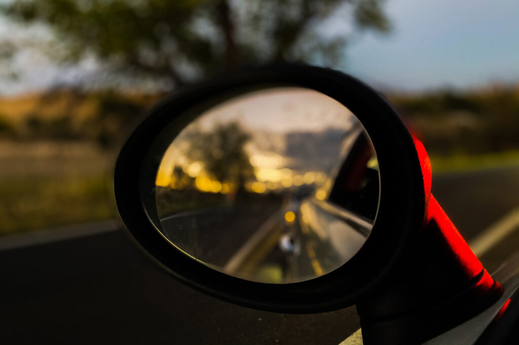 A Side View Mirror With Stick On Glass